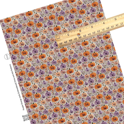 Leaves with purple and orange pumpkins on gray faux leather sheets