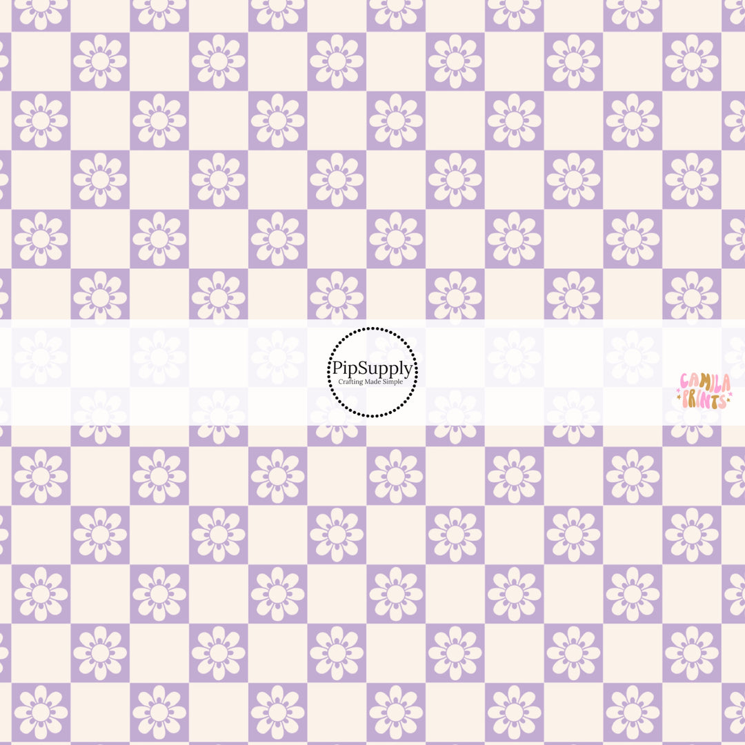 This spring fabric by the yard features daisy flowers on purple and cream checkers. This fun pattern fabric can be used for all your sewing and crafting needs!