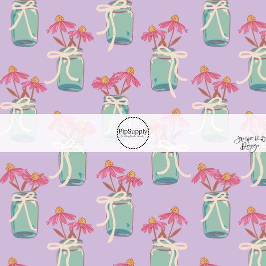 This summer fabric by the yard features flowers in a mason jar on purple. This fun summer themed fabric can be used for all your sewing and crafting needs!