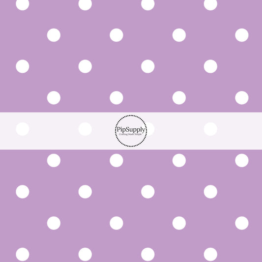This celebration fabric by the yard features white dots on light purple. This fun themed fabric can be used for all your sewing and crafting needs!