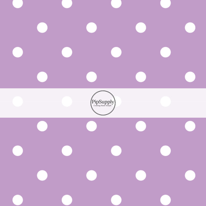 This celebration fabric by the yard features white dots on light purple. This fun themed fabric can be used for all your sewing and crafting needs!