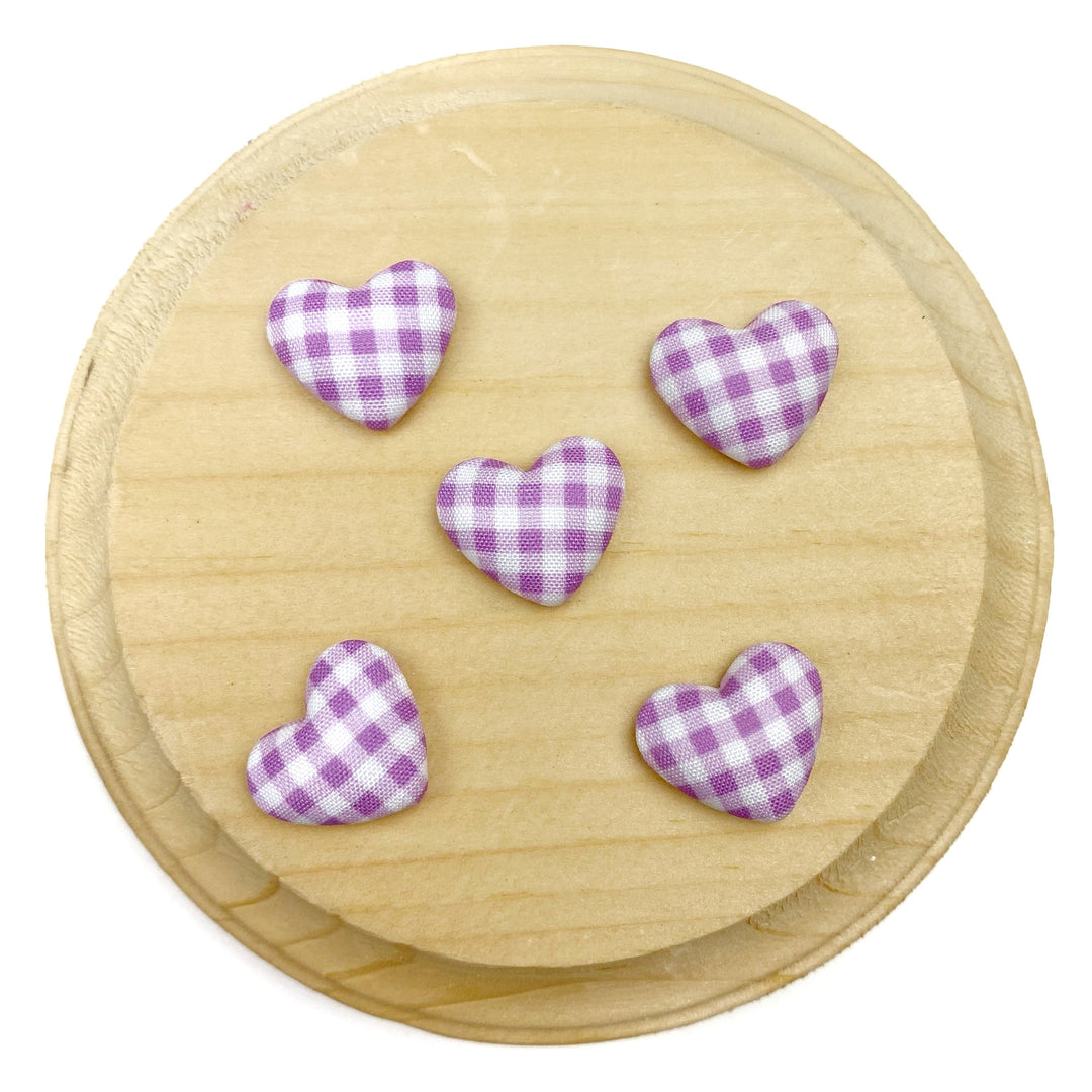 Heart-shaped flat back embellishment featuring a purple and white gingham plaid pattern with a softly padded, fabric-covered appearance. Finished with smooth edges and a charming, classic design, perfect for bows, hair accessories, scrapbooking, and craft projects.

Silver, flat backing
Sets of 10
Approx 1.9cm l x 1.58cm 