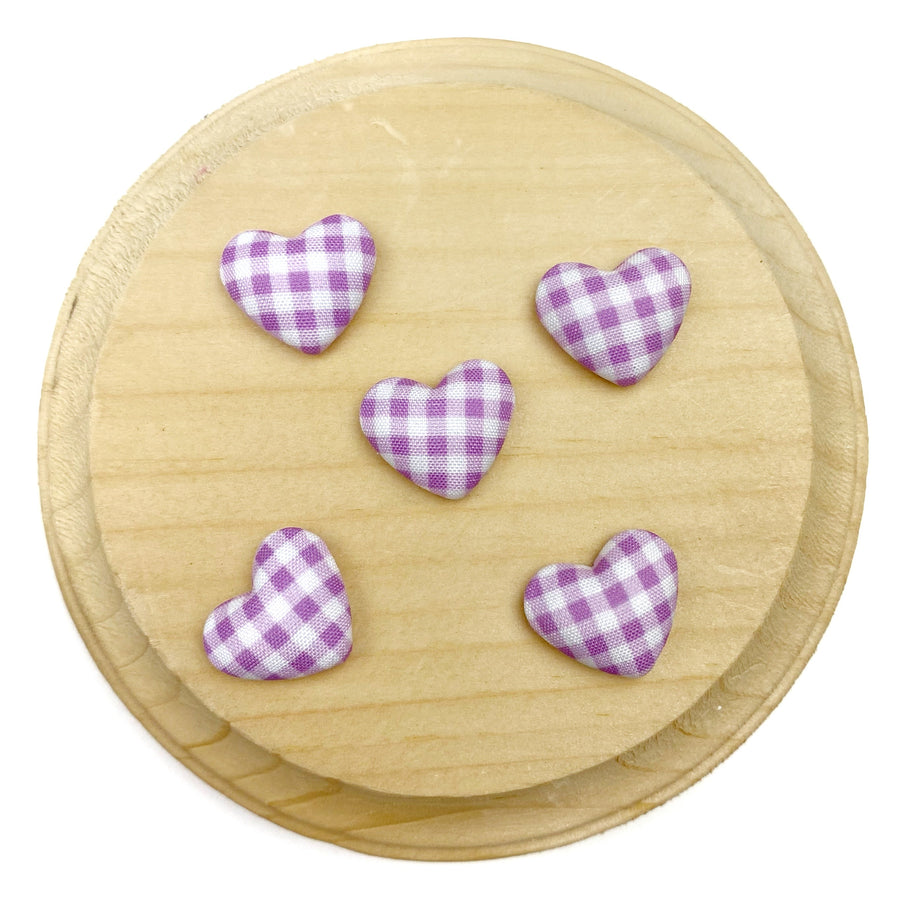 Heart-shaped flat back embellishment featuring a purple and white gingham plaid pattern with a softly padded, fabric-covered appearance. Finished with smooth edges and a charming, classic design, perfect for bows, hair accessories, scrapbooking, and craft projects.

Silver, flat backing
Sets of 10
Approx 1.9cm l x 1.58cm 