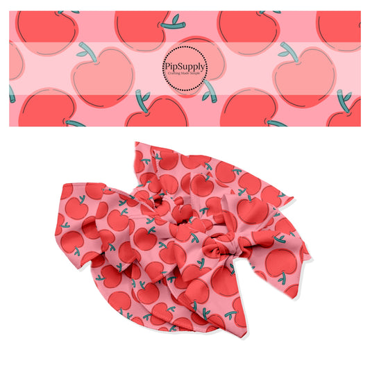 Bright red apples on pink bow strips