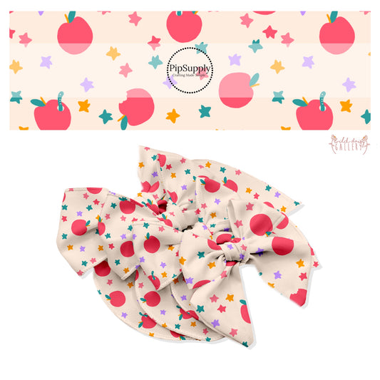 Red apples with green worms with multi scattered stars on cream bow strips
