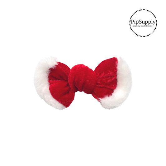 white fur on ends of red tied hair bow