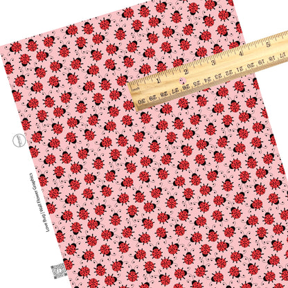 Scattered lady bugs on pink faux leather sheets