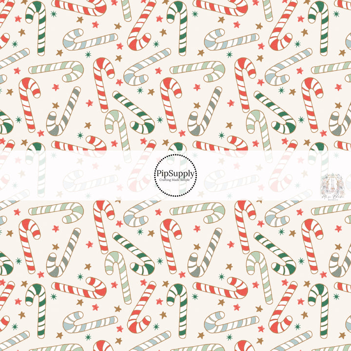 These Christmas themed pattern fabric by the yard features the following design elements: candy canes on cream. This fun themed fabric can be used for all your sewing and crafting needs!