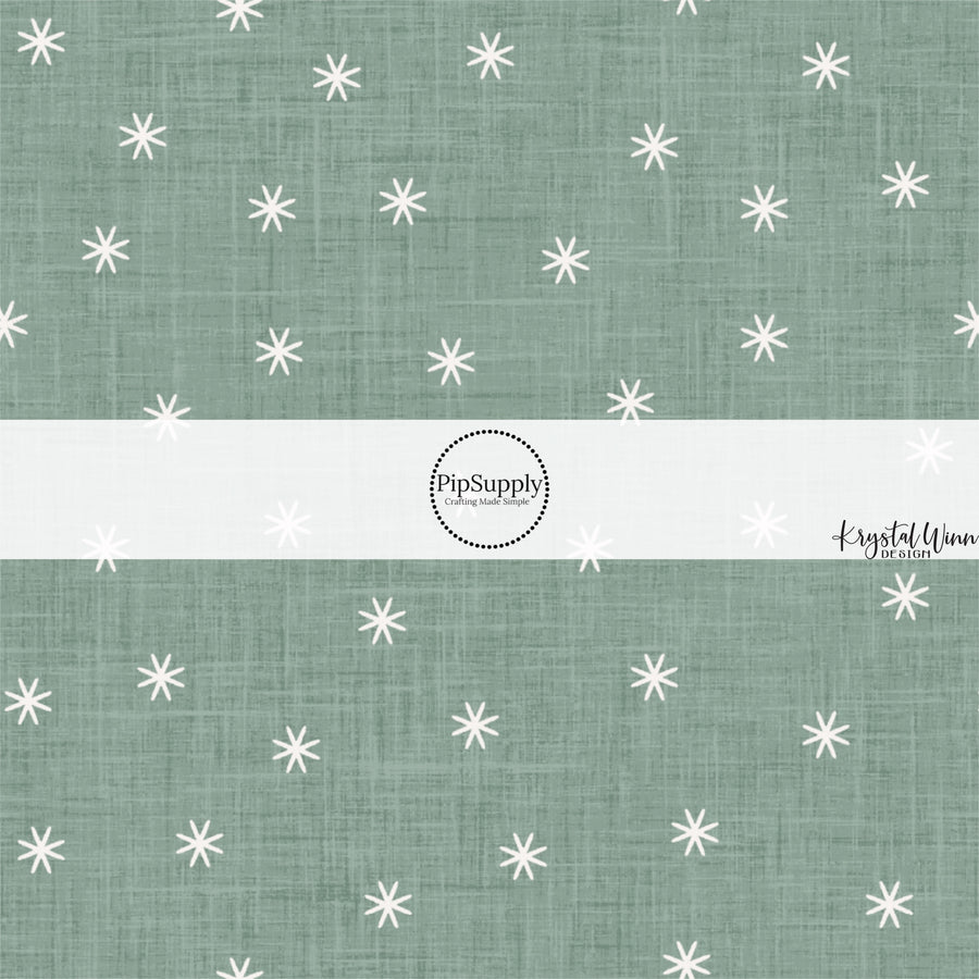 These winter themed pattern fabric by the yard features the following design elements: tiny white snowflakes on sage. This fun themed fabric can be used for all your sewing and crafting needs!