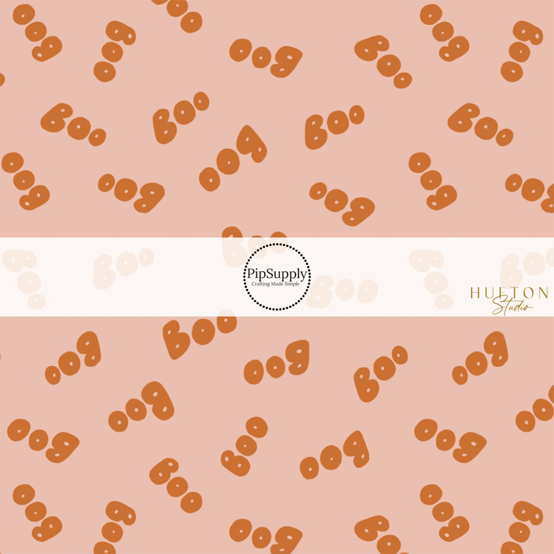 These Halloween themed pattern fabric by the yard features the following design elements: orange "BOO" on light pink. This fun spooky themed fabric can be used for all your sewing and crafting needs!