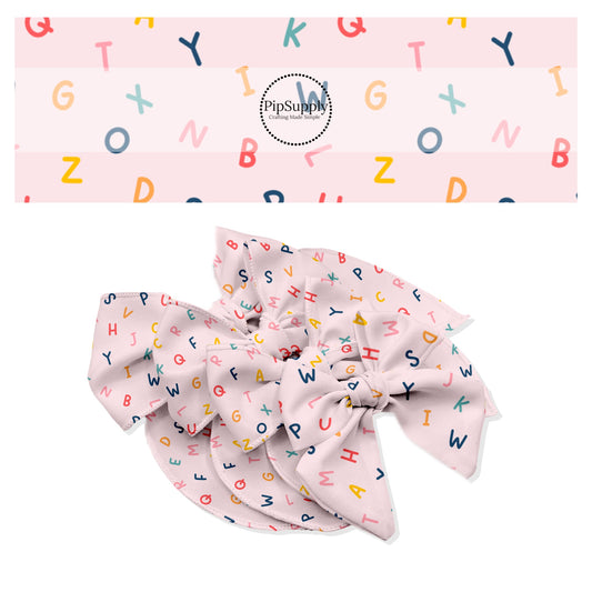 Scattered multi colorful letters on light pink bow strips