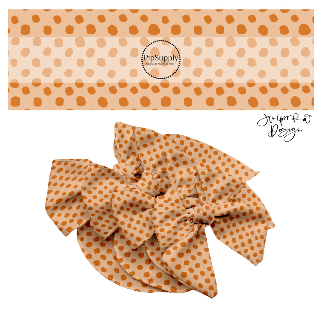 Orange speckles on beige hair bow strips