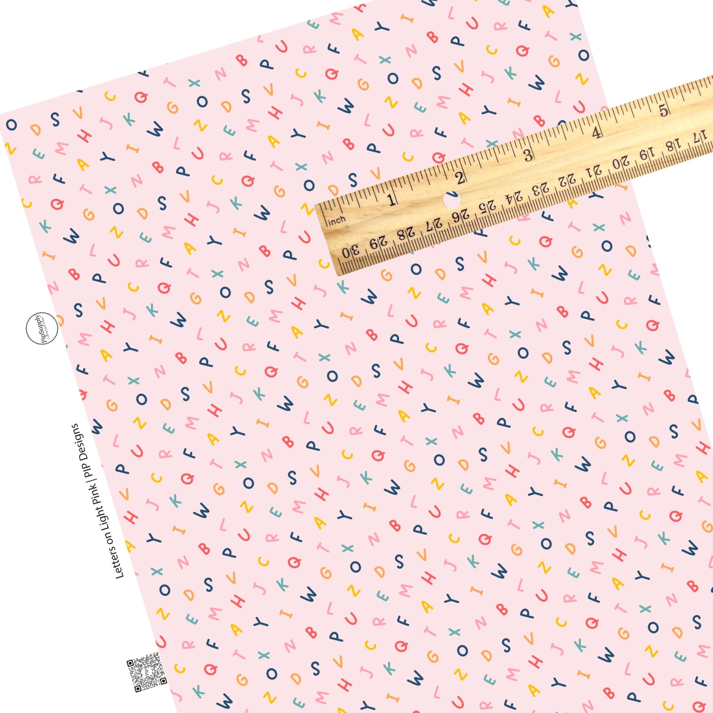 Scattered alphabet on light pink faux leather sheets
