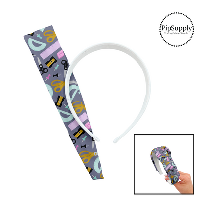 Scissors, rulers, push pins, sharpener, and erasers on gray knotted headband kit