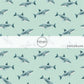 These shark themed blue fabric by the yard features sharks on light blue. This fun ocean themed fabric can be used for all your sewing and crafting needs! 