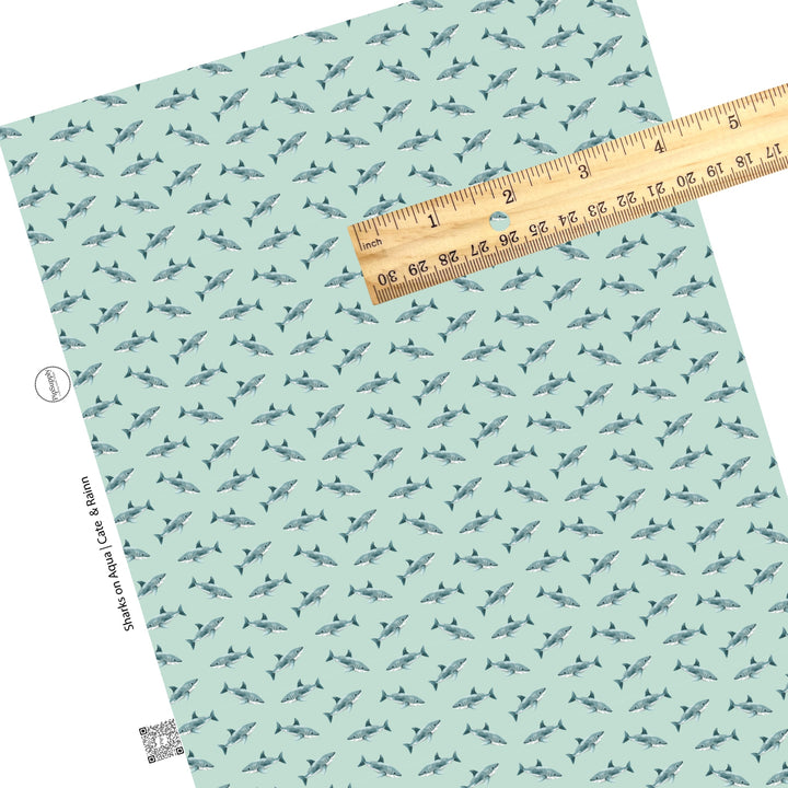 These shark themed blue faux leather sheets contain the following design elements: sharks on light blue. Our CPSIA compliant faux leather sheets or rolls can be used for all types of crafting projects.