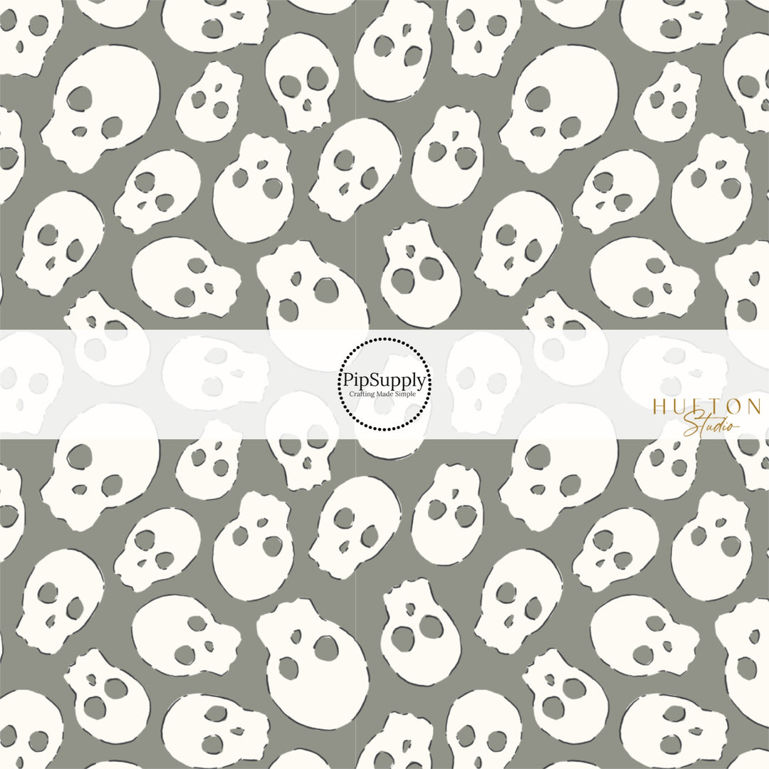 These Halloween themed pattern fabric by the yard features the following design elements: cream skulls on gray. This fun spooky themed fabric can be used for all your sewing and crafting needs!