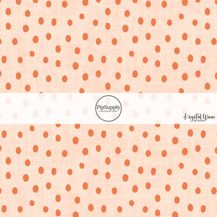 This light orange fabric by the yard features small dark orange dots on light orange. 