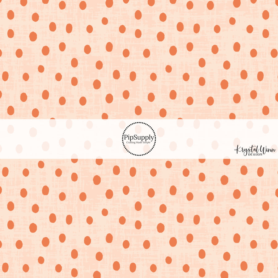 This light orange fabric by the yard features small dark orange dots on light orange. 