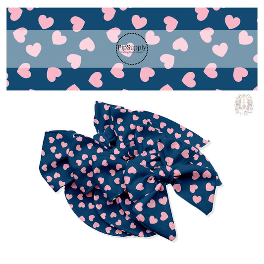 Light pink hearts in various directions on navy blue hair bow strips. 