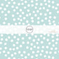 These small dots on a light teal fabric by the yard features small dots in white scattered on a teal blue background.