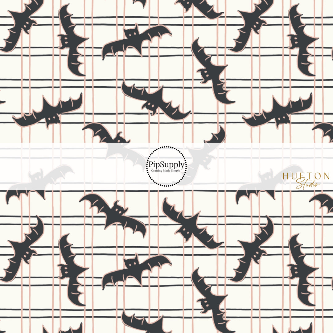 These Halloween themed pattern fabric by the yard features the following design elements: bats on grid pattern on cream. This fun spooky themed fabric can be used for all your sewing and crafting needs!