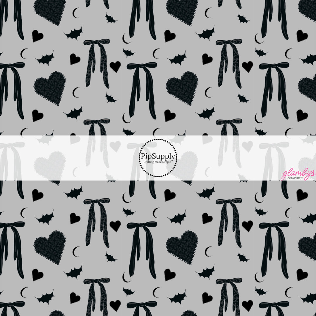 These Halloween themed pattern fabric by the yard features the following design elements: bows, hearts, and bats on gray. This fun spooky themed fabric can be used for all your sewing and crafting needs!