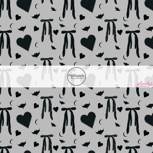 These Halloween themed pattern fabric by the yard features the following design elements: bows, hearts, and bats on gray. This fun spooky themed fabric can be used for all your sewing and crafting needs!