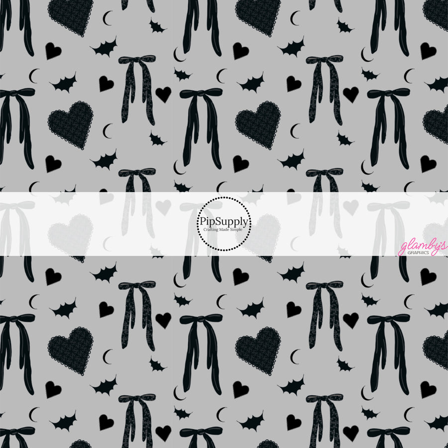 These Halloween themed pattern fabric by the yard features the following design elements: bows, hearts, and bats on gray. This fun spooky themed fabric can be used for all your sewing and crafting needs!