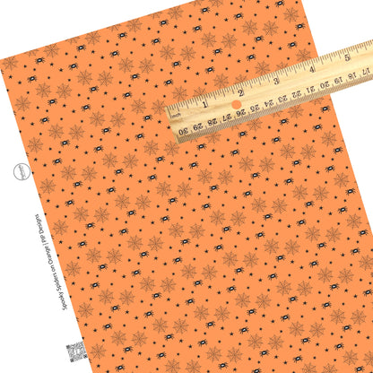 Black spiders with webs and stars on orange faux leather sheets