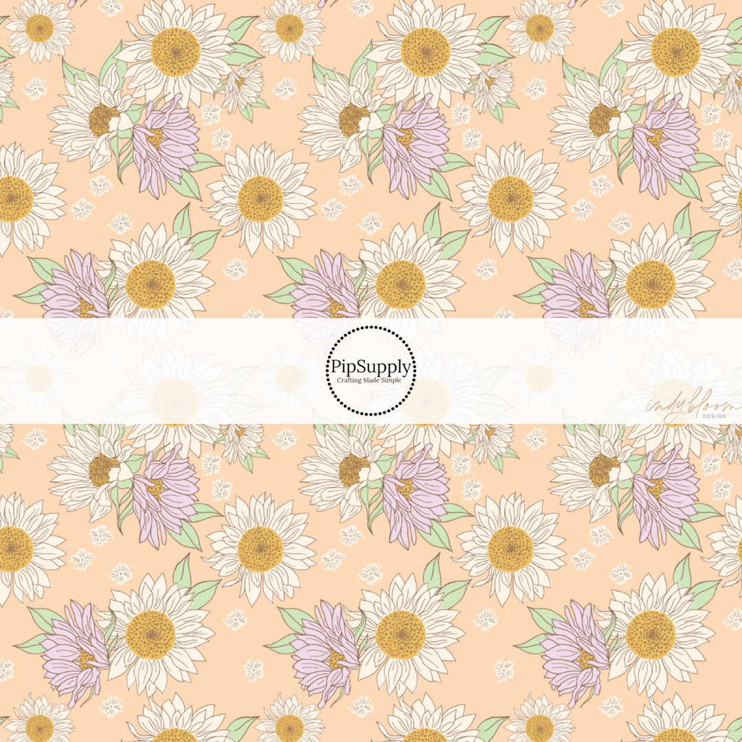 These spring fabric by the yard features lilac sunflowers on peach. This fun pattern fabric can be used for all your sewing and crafting needs!