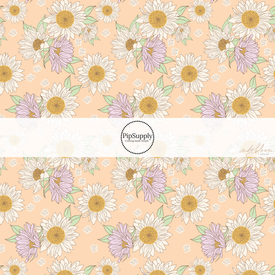 These spring fabric by the yard features lilac sunflowers on peach. This fun pattern fabric can be used for all your sewing and crafting needs!