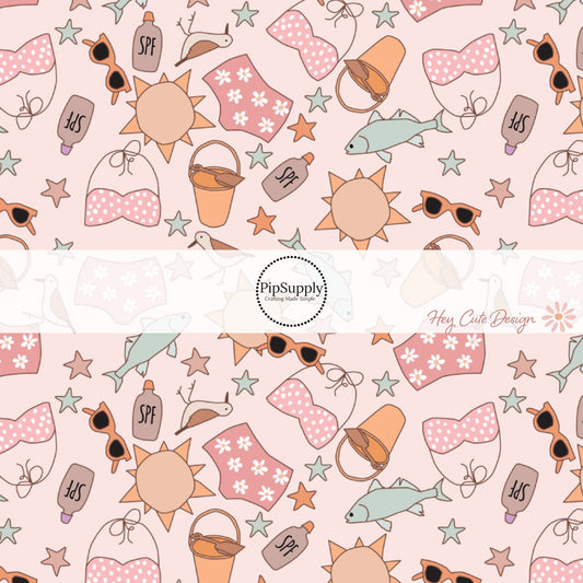 This summer fabric by the yard features beach swimsuits, sand pails, fish, birds, and sunshine on pink. This fun themed fabric can be used for all your sewing and crafting needs!