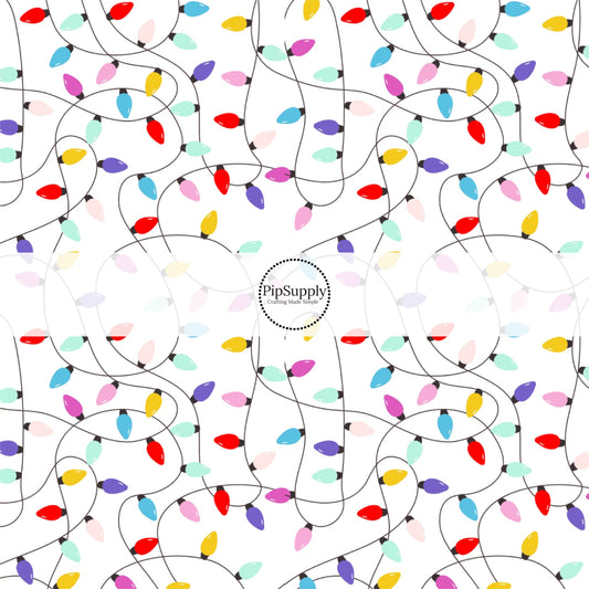 These Santa themed pattern fabric by the yard features the following design elements: colorful Christmas lights on white. This fun themed fabric can be used for all your sewing and crafting needs!