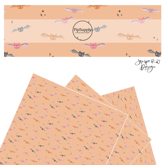 Pink, orange, purple, and gray bats with stars on peach faux leather sheets