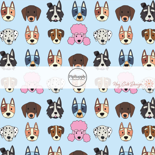 These dog themed light blue fabric by the yard features variety of different dog faces