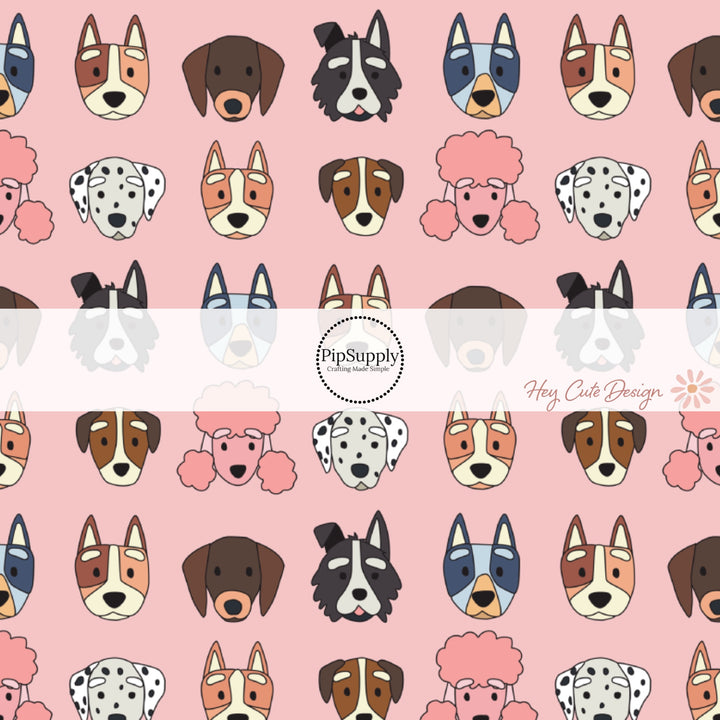 These dog themed light pink fabric by the yard features variety of different dog faces. 