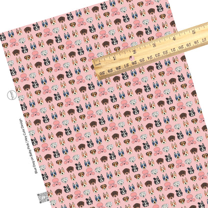 These dog themed light pink faux leather sheets contain the following design elements: variety of different dog faces. 