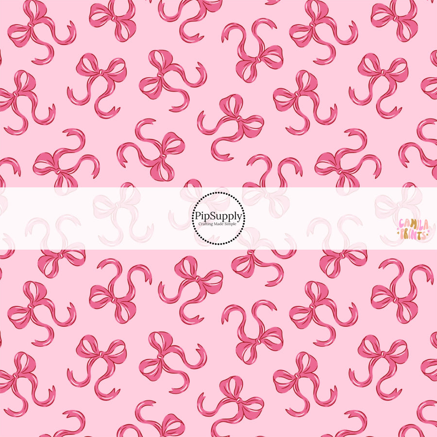 This holiday fabric by the yard features bows on pink. This festive pattern fabric can be used for all your sewing and crafting needs!