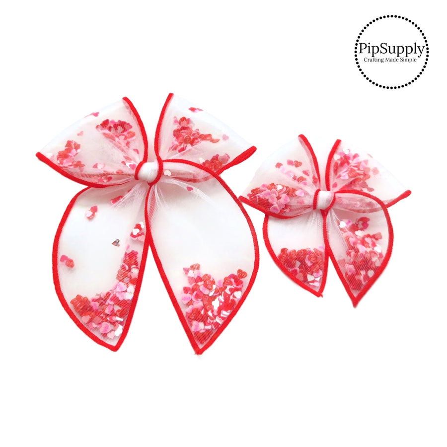 These Valentine's Day red stitched white tulle pre-cut shaker tied bows are ready to package and resell to your customers no sewing or measuring necessary! These hair bows come with a alligator clip already attached and come filled with colorful heart sequins.