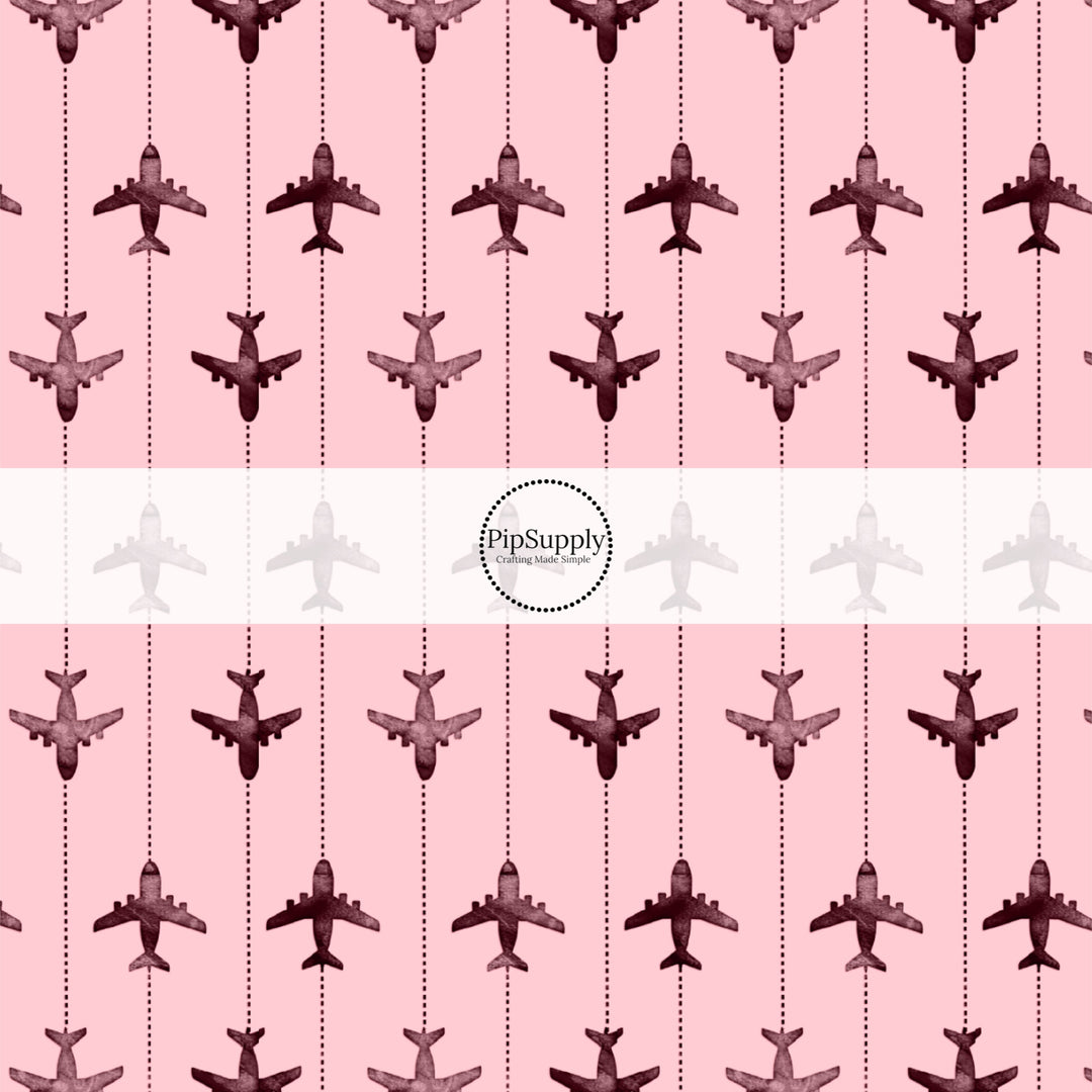 These travel themed fabric by the yard features airplanes on pink pattern. This fun pattern fabric can be used for all your sewing and crafting needs!