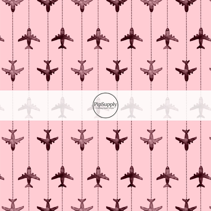 These travel themed fabric by the yard features airplanes on pink pattern. This fun pattern fabric can be used for all your sewing and crafting needs!