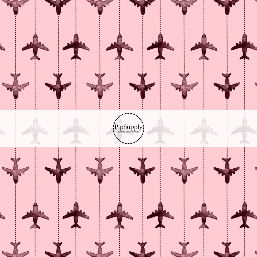 These travel themed fabric by the yard features airplanes on pink pattern. This fun pattern fabric can be used for all your sewing and crafting needs!