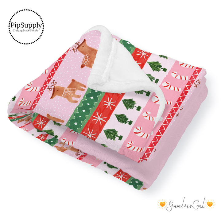 This winter designer pattern is printed onto the front side of our soft touch minky blankets. The backside will not be printed and left the natural cream/white color of the blanket. This print pattern features rows of reindeer, candy canes, and Christmas trees on pink.