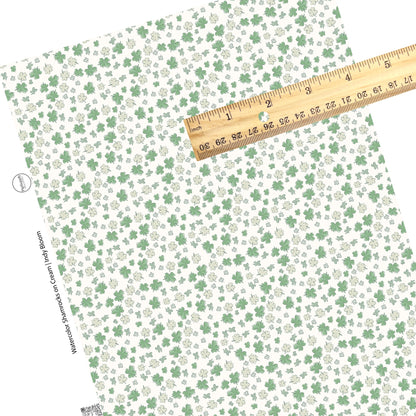 These St. Patrick's pattern themed faux leather sheets contain the following design elements: green and light green shamrocks on cream. Our CPSIA compliant faux leather sheets or rolls can be used for all types of crafting projects.