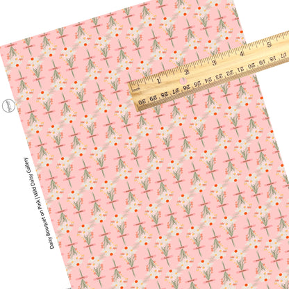 These wildflower daisy themed light pink faux leather sheets contain the following design elements: white, cream, yellow, and orange daisy flower bouquets with pink ribbons. 