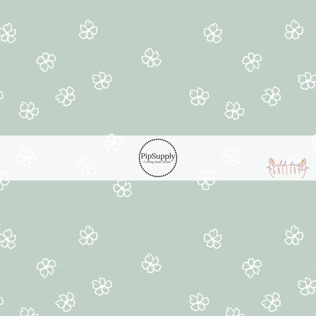 These daisy themed light seafoam green fabric by the yard features white outlined daisies on seafoam.