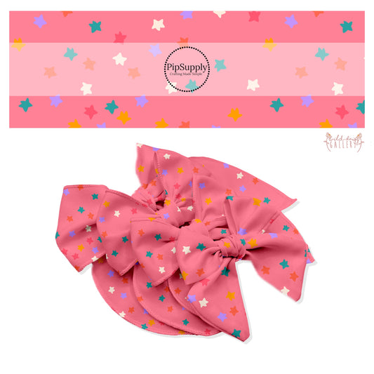 Pink, white, teal, gold, and purple scattered stars on pink bow strips