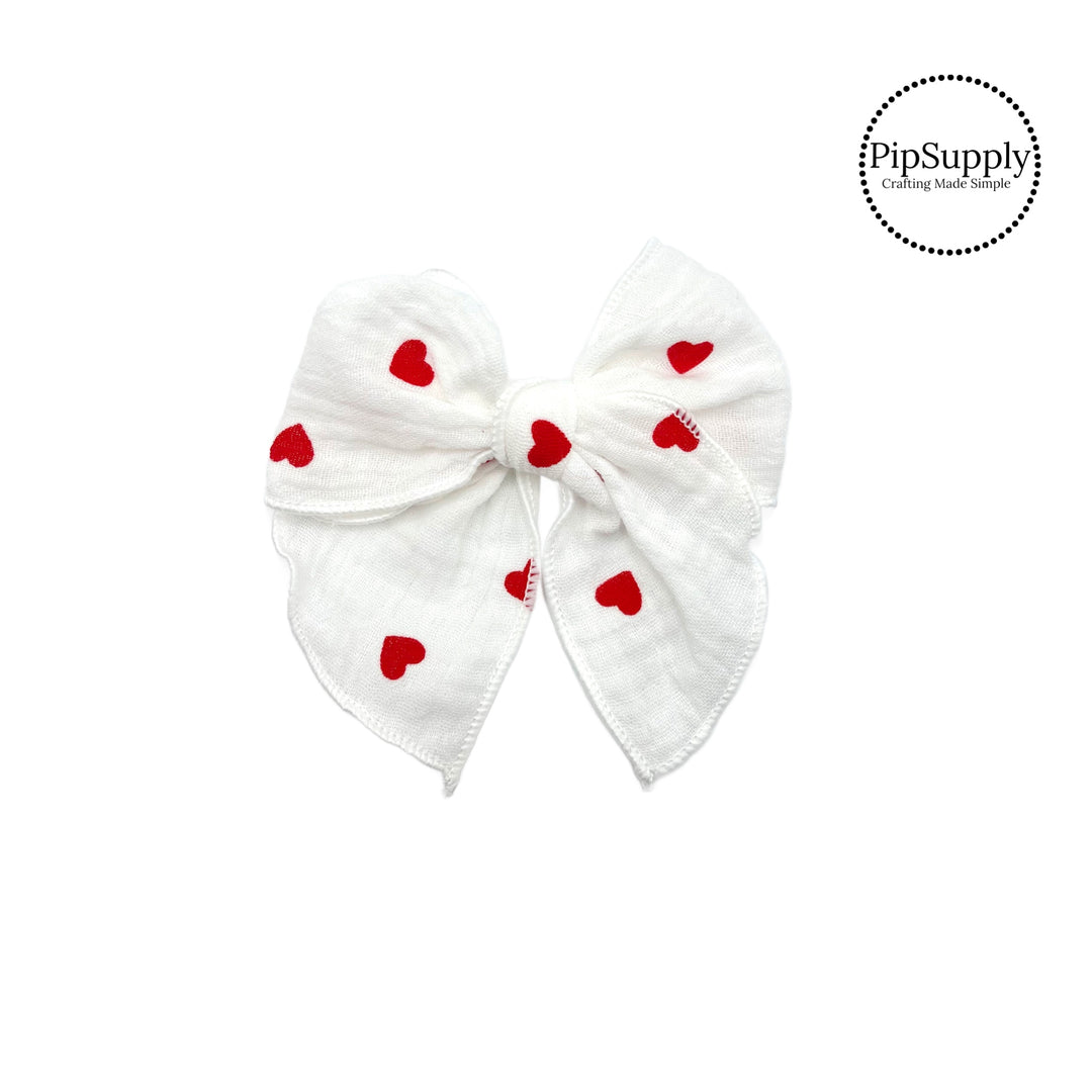 These white muslin with red hearts pre-cut tied bows are ready to package and resell to your customers no sewing or measuring necessary! These hair bows come with a alligator clip already attached.