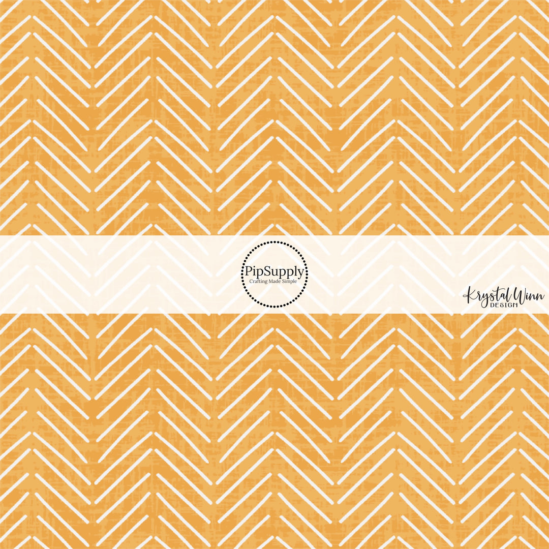 These mustard colored fabric by the yard features white arrows on light orange.